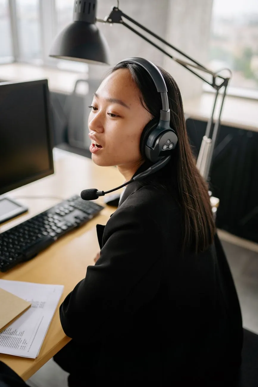 A streamer wearing a headset working at a home desk